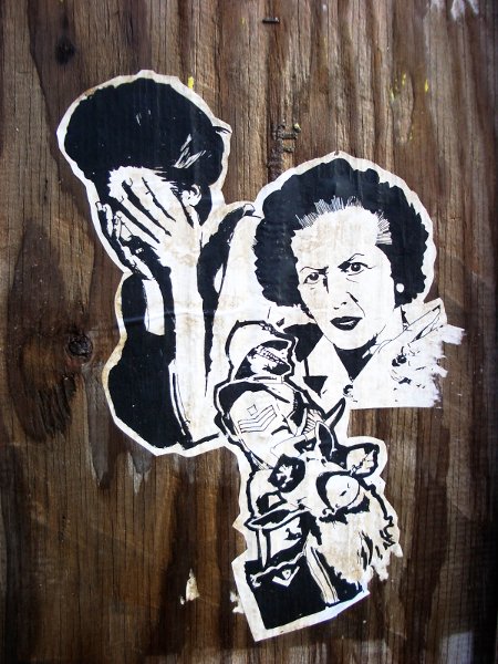 Margaret Thatcher launched a vicious attack on the working class, using the police to quell dissent. Photo of anonymous street art by bixentro.