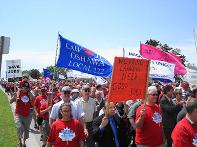 In June of 2008 General Motors announced the closure of their Oshawa truck plant. A militant demonstration of 5,000 workers marched around the plant with the main slogan “SAVE OUR JOBS!”