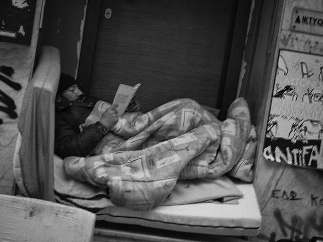 Homeless reading Athens By Sascha Kohlmann CC BY SA 2.0 