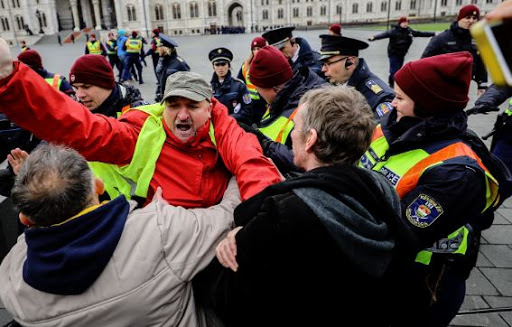 Imre Komjáthy vice president of the Socialist Party manhandled outside Parliament by the Police