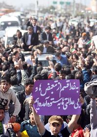 During President Mahmoud Ahmadinejad's March 2 trip to Lorestan province, in western Iran, the protesters weren't waving green banners -- at least not the ones that the official ISNA photographer appears to have inadvertently snapped. A purple sign held up by one young man reads, "Swear to God, we've come to a breaking point from all the discrimination and injustice."  