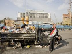 February 1 - A burnt down police van, turned into a garbage dumb, with a banner: "NDP Headquarters" - Photo: 3arabwy