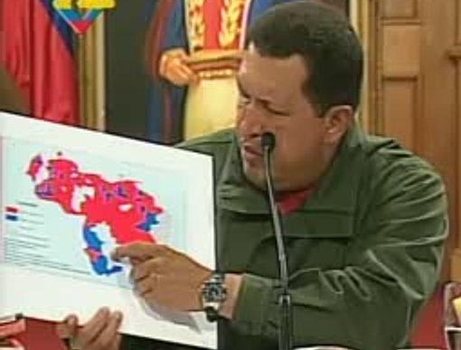 Chávez shows a map showing council election results