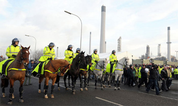 Mounted police stand by as workers protest outside the Lindsey oil refinery in North Lincolnshire