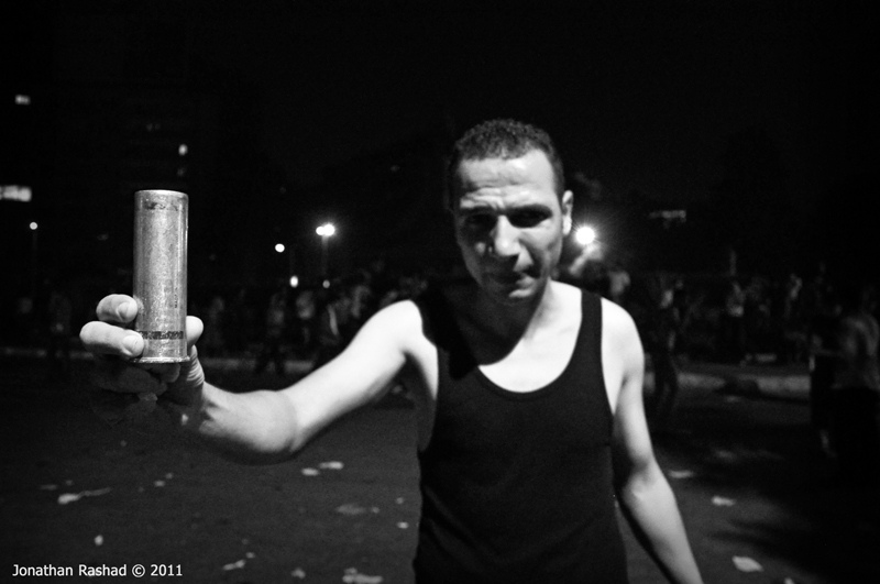 Clashes outside the Israeli embassy. Protester holding US manufactured tear gas canister. Photo: Jonathan Rashad