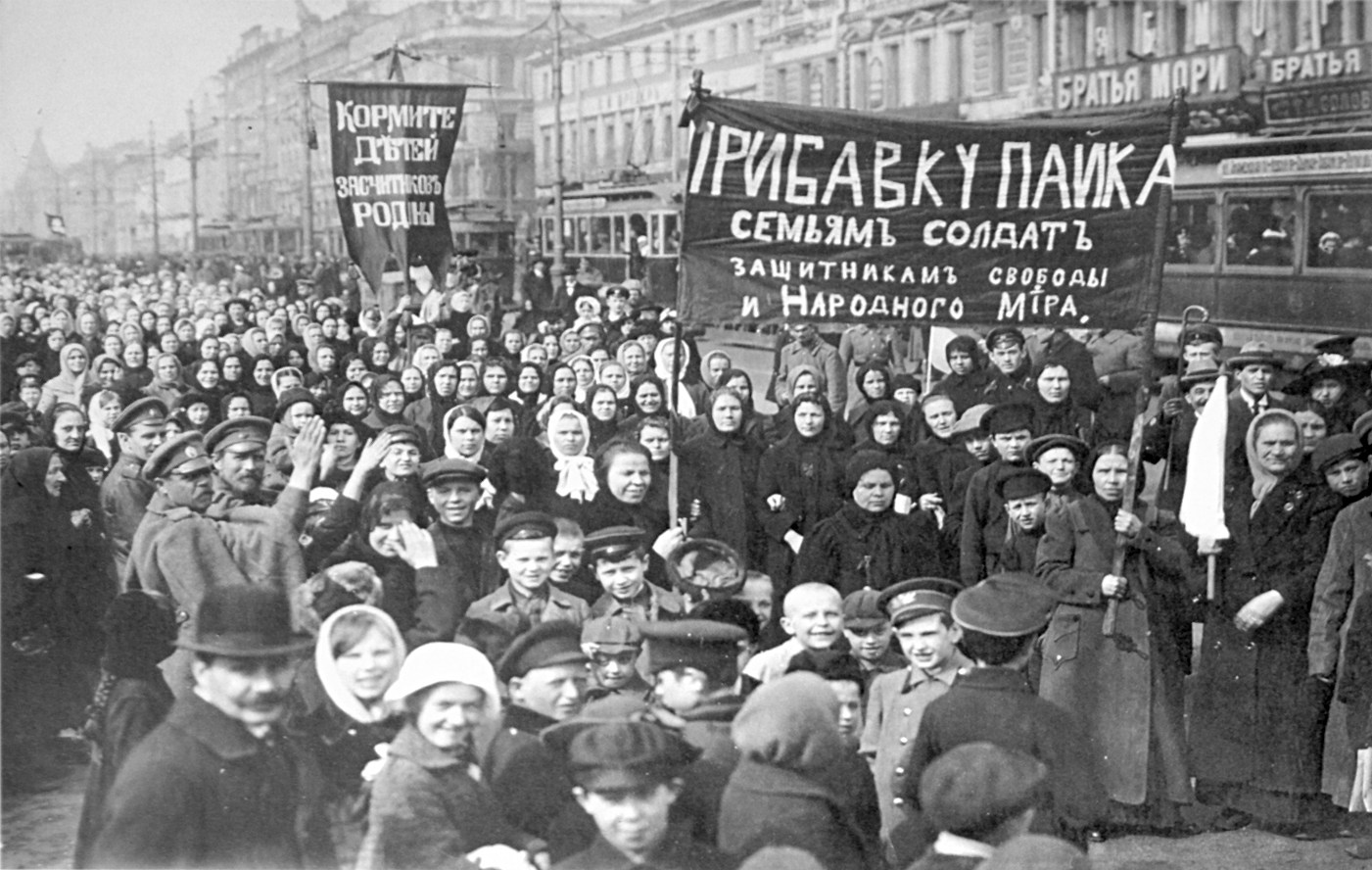 Putilov workers during February Revolution. left banner Feed the children of the defenders right banner Increase payments to the soldiers families defenders of freedom and world peace Public Domain
