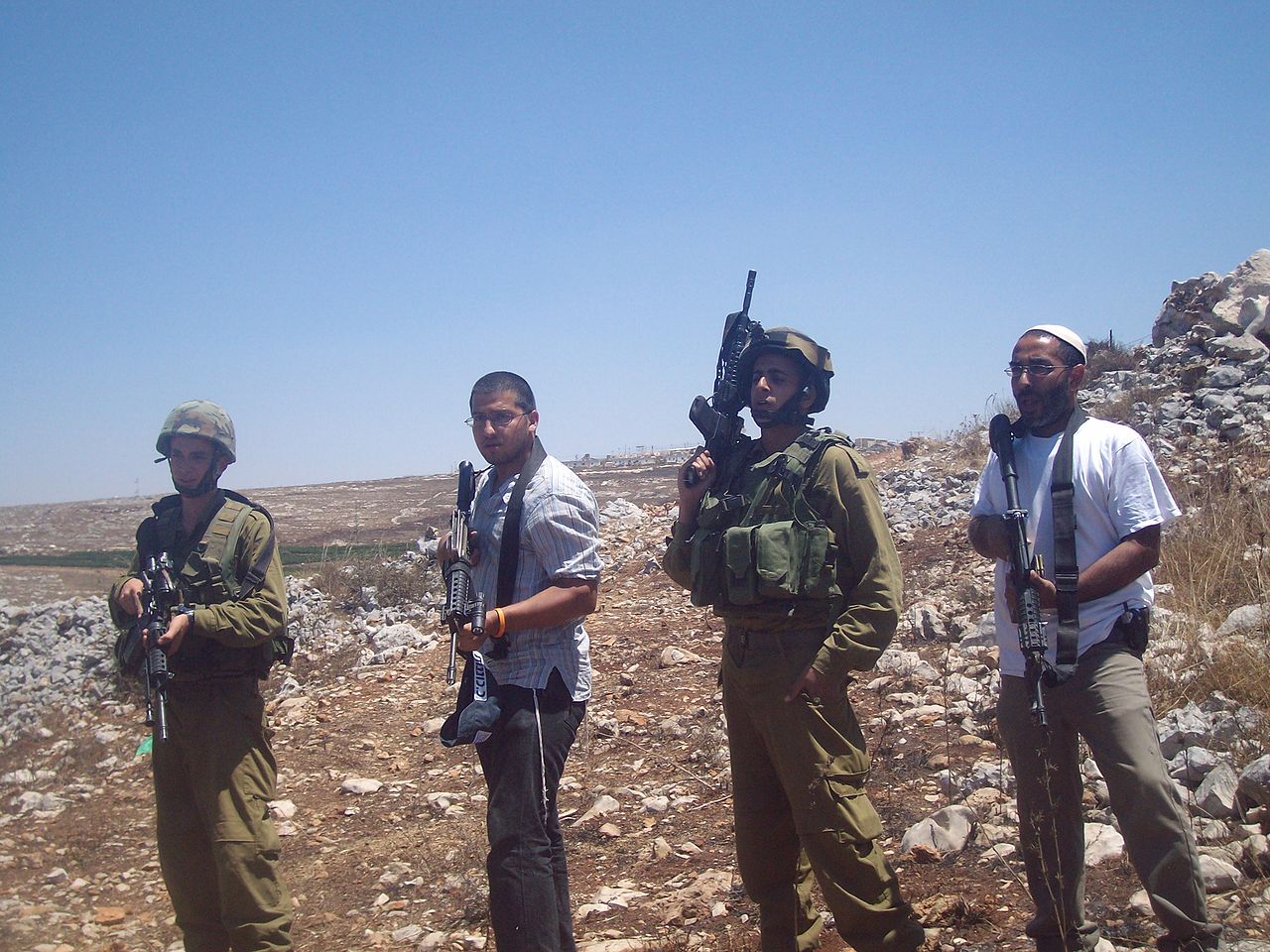 以色列迁占者正在利用以色列士兵的力量和装备来实现他们的计划。//图片来源：ISM Palestine, Wikimedia Commons