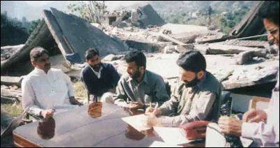 Manzoor Ahmed (left) in Kashmir after the Earthquake